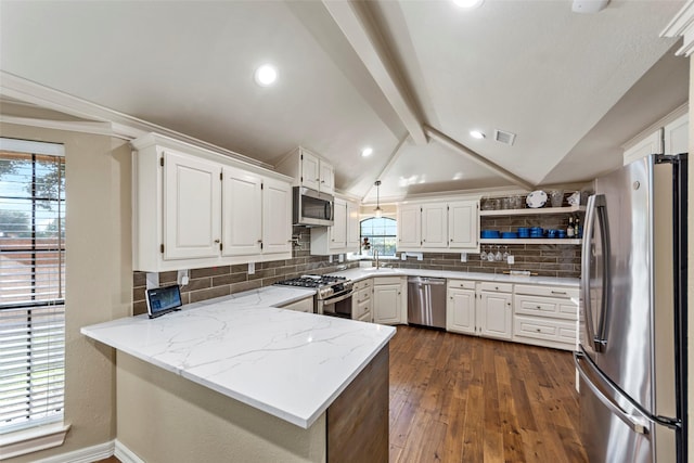 kitchen with kitchen peninsula, white cabinetry, vaulted ceiling with beams, and appliances with stainless steel finishes