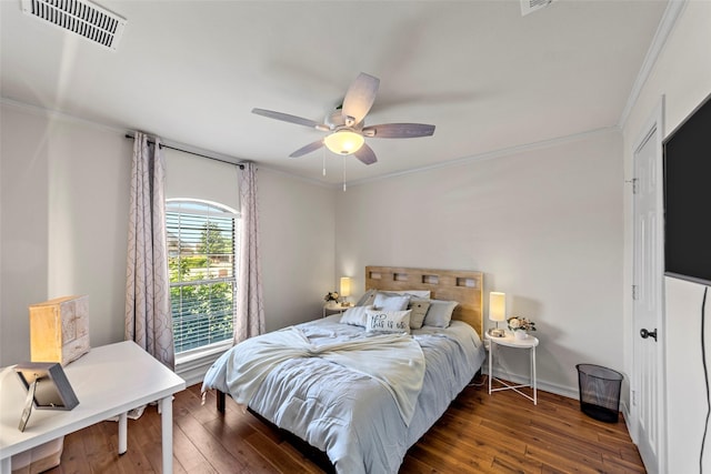 bedroom featuring ceiling fan, dark hardwood / wood-style floors, and ornamental molding