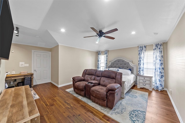 bedroom with ceiling fan, dark hardwood / wood-style floors, ornamental molding, and multiple windows