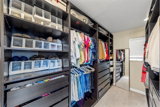 walk in closet featuring carpet flooring