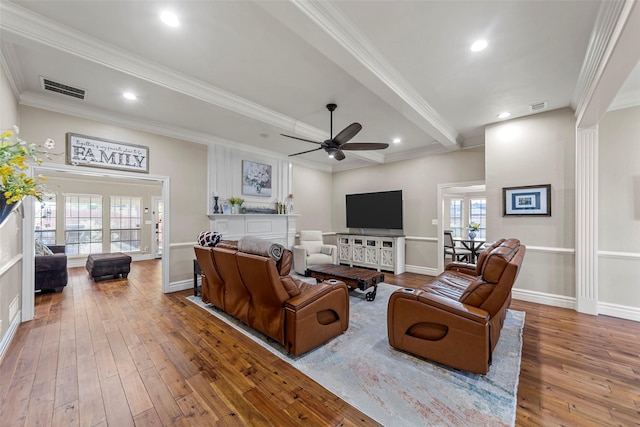 living room with wood-type flooring, ceiling fan, and crown molding