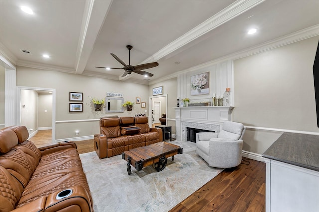 living room featuring a high end fireplace, crown molding, beamed ceiling, and dark hardwood / wood-style floors