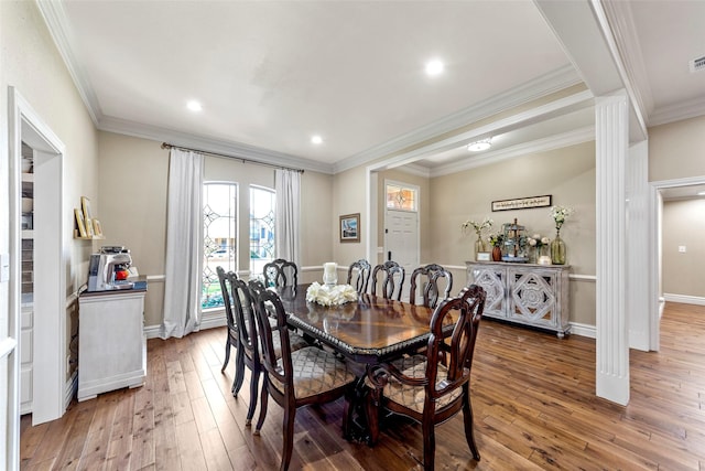 dining room featuring hardwood / wood-style flooring and ornamental molding