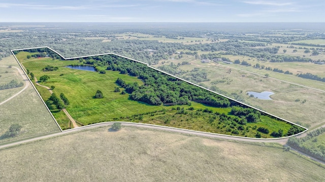 drone / aerial view featuring a rural view and a water view