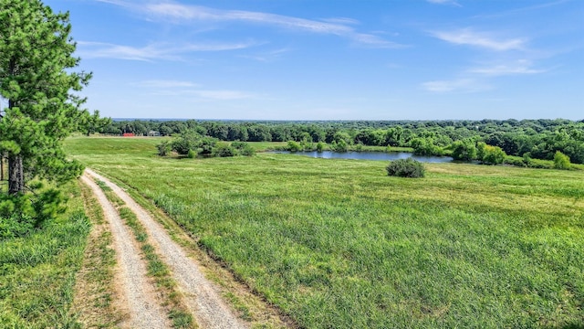 view of yard featuring a rural view and a water view