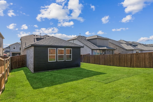 rear view of property with a lawn