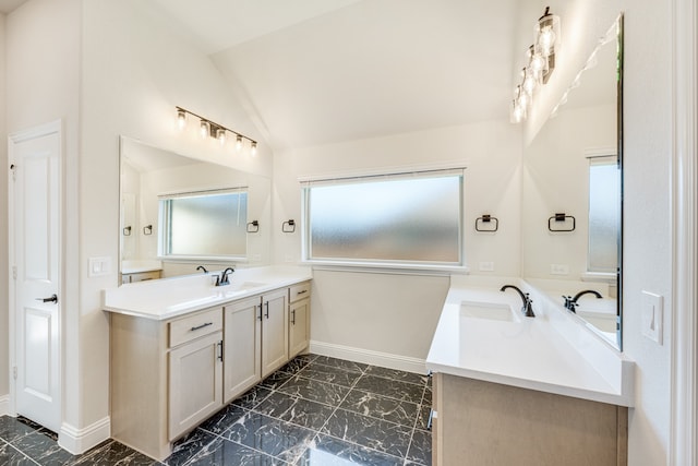 bathroom featuring vanity and vaulted ceiling