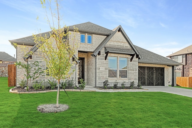 view of front of house with a garage and a front lawn