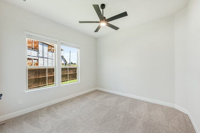 empty room featuring light carpet and ceiling fan