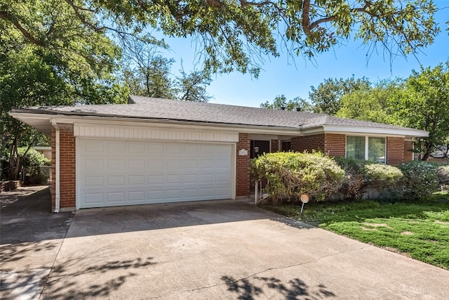 single story home featuring a front yard and a garage