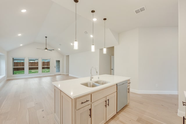 kitchen with hanging light fixtures, sink, stainless steel dishwasher, and light wood-type flooring