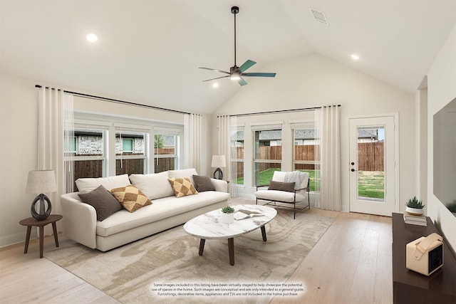 living room featuring ceiling fan, high vaulted ceiling, and light hardwood / wood-style flooring