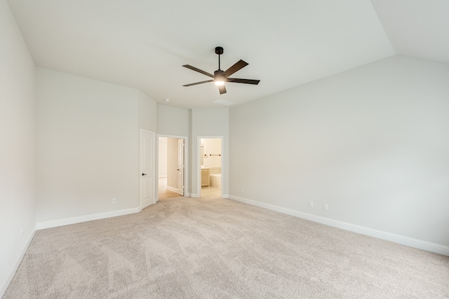 unfurnished bedroom with ensuite bath, ceiling fan, light colored carpet, and lofted ceiling