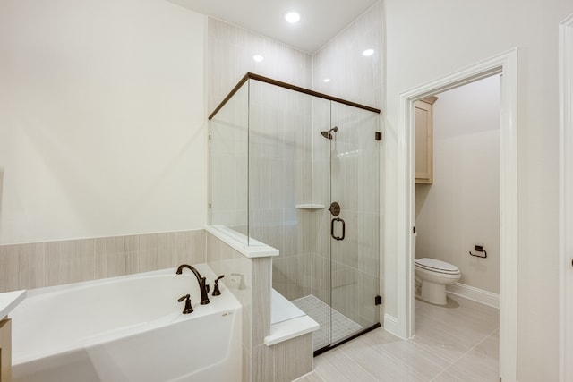 bathroom with tile patterned floors, toilet, and independent shower and bath