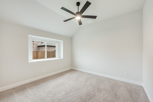 unfurnished room with ceiling fan, carpet floors, and lofted ceiling