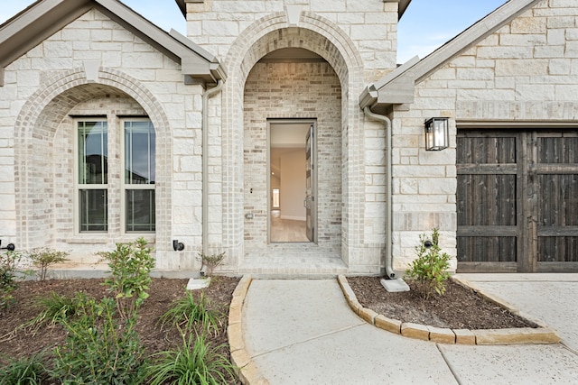 doorway to property with a garage