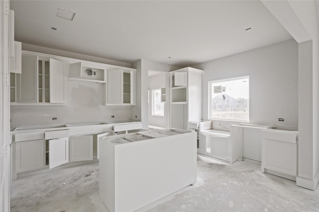 kitchen featuring a kitchen island and white cabinetry