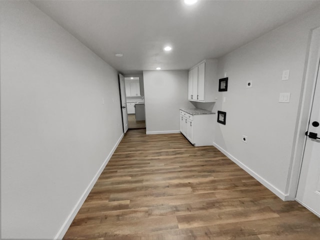 clothes washing area featuring hardwood / wood-style floors and hookup for an electric dryer