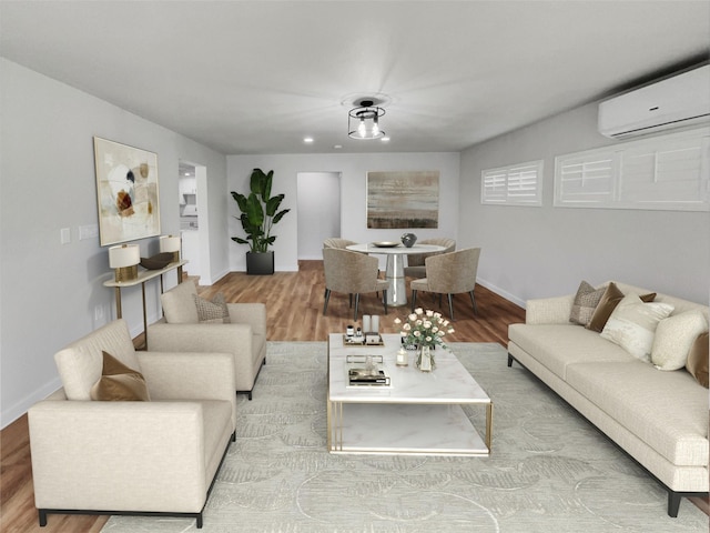 living room with light wood-type flooring and an AC wall unit