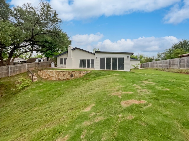 back of property featuring a yard