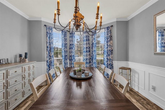 dining space with crown molding and a chandelier