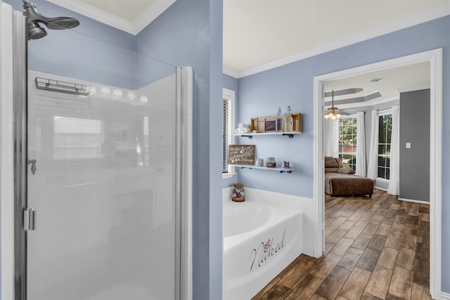 bathroom with crown molding, ceiling fan, a shower stall, a bath, and wood finished floors