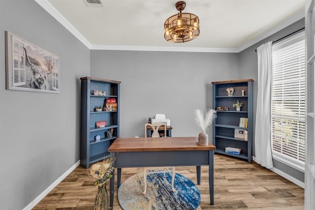 office area with hardwood / wood-style floors and crown molding