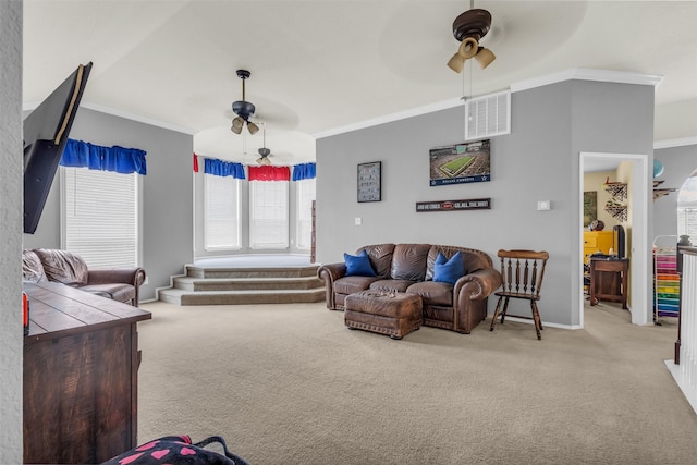 living area with ornamental molding, visible vents, ceiling fan, and carpet flooring