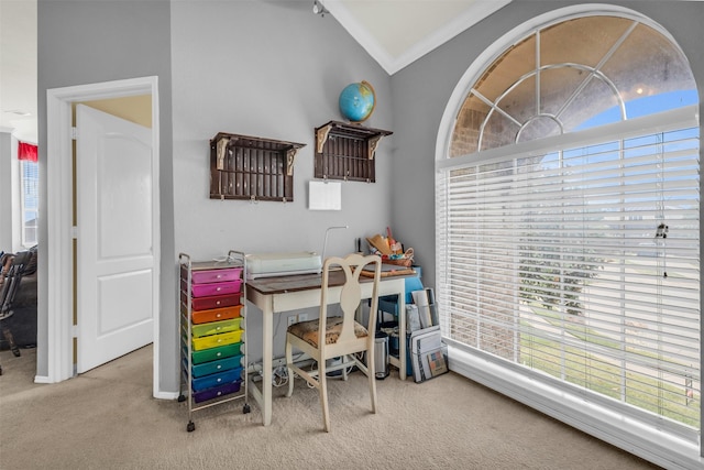 carpeted home office with crown molding, baseboards, and lofted ceiling