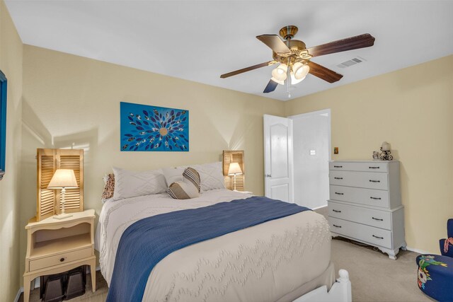 bedroom featuring visible vents, baseboards, a ceiling fan, and light colored carpet