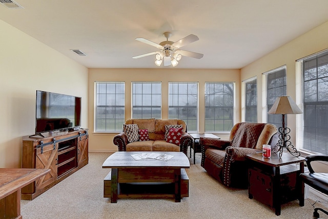 carpeted living room featuring ceiling fan and plenty of natural light