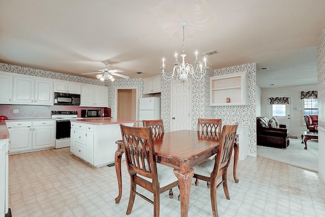 dining room with ceiling fan with notable chandelier