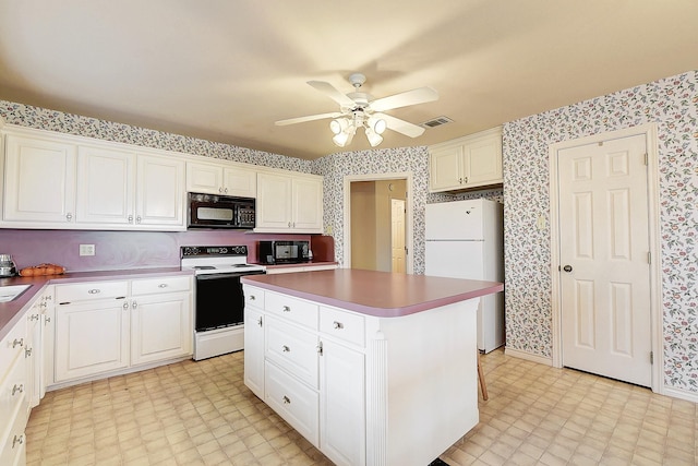 kitchen featuring white cabinetry, white appliances, a center island, and ceiling fan