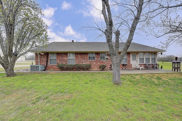 rear view of property with a yard, cooling unit, and a patio area