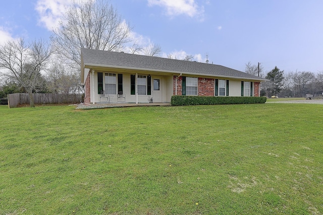 single story home with covered porch and a front yard