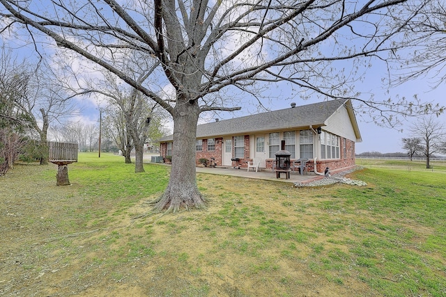 exterior space featuring a lawn and a patio area