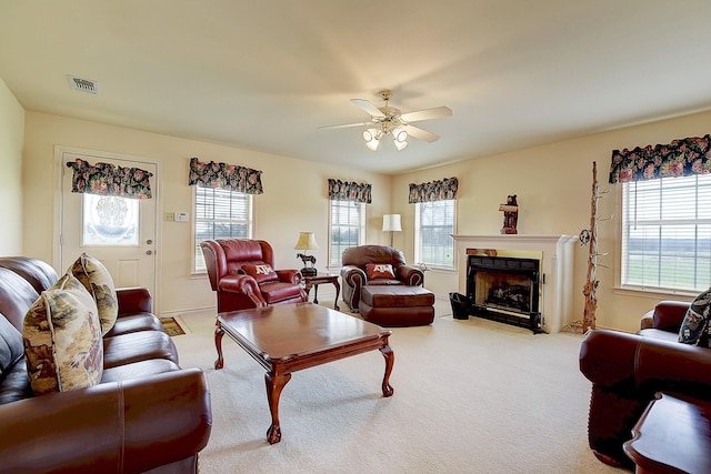 carpeted living room featuring a wealth of natural light and ceiling fan