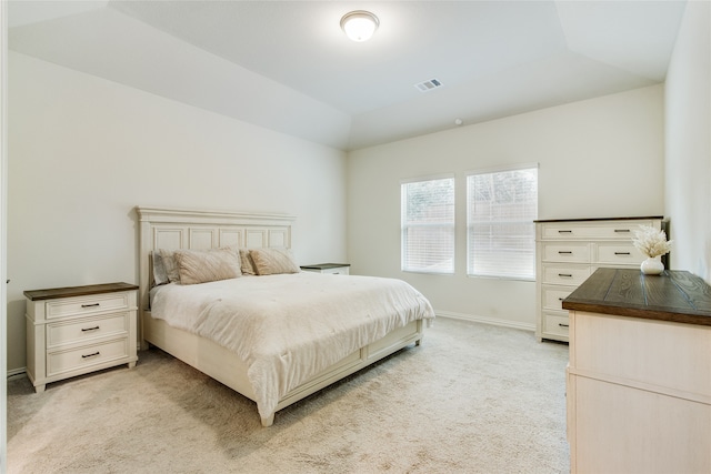 bedroom featuring light colored carpet and vaulted ceiling