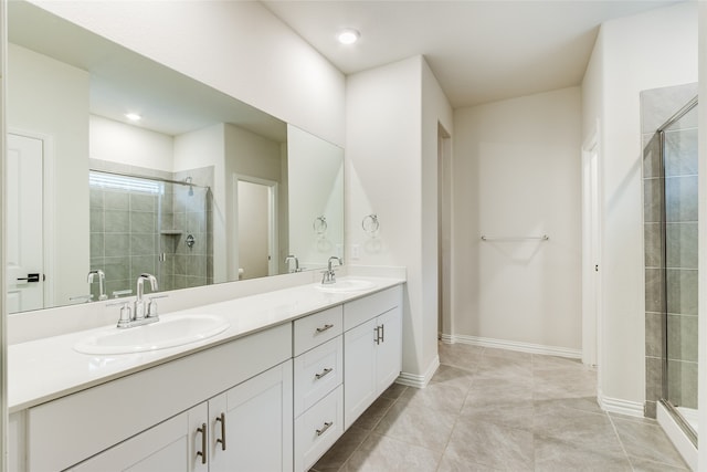 bathroom with tile patterned floors, walk in shower, and double vanity