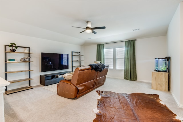 carpeted living room featuring ceiling fan