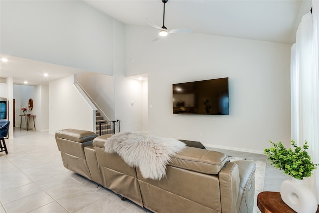 living room featuring high vaulted ceiling, ceiling fan, and light tile patterned floors