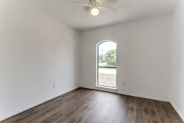 spare room with ceiling fan and dark hardwood / wood-style floors