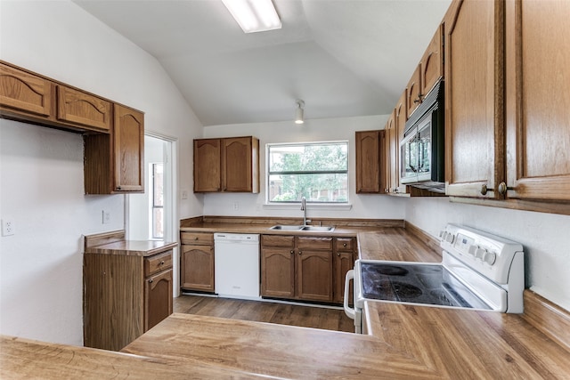 kitchen with lofted ceiling, white appliances, dark wood-type flooring, and sink