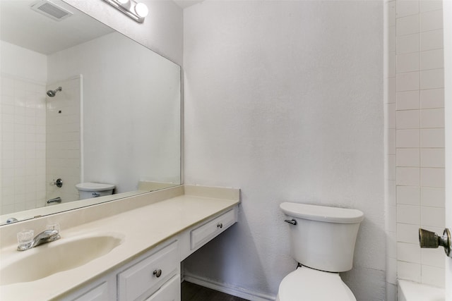 full bath featuring toilet, visible vents,  shower combination, and vanity