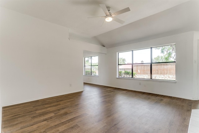 unfurnished room with ceiling fan, baseboards, vaulted ceiling, and dark wood-type flooring