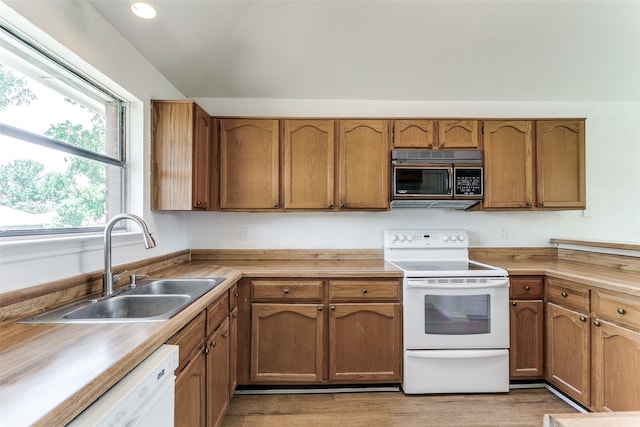 kitchen with light hardwood / wood-style flooring, sink, and white appliances