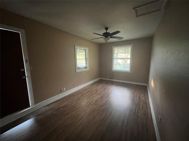 unfurnished room with ceiling fan and dark hardwood / wood-style flooring