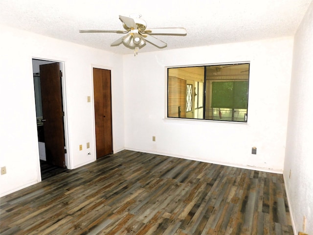 unfurnished room featuring dark hardwood / wood-style flooring, a textured ceiling, and ceiling fan