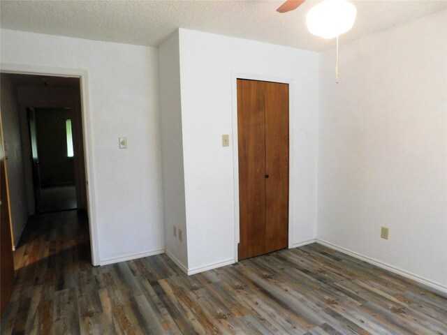 spare room with a textured ceiling, dark hardwood / wood-style flooring, and ceiling fan