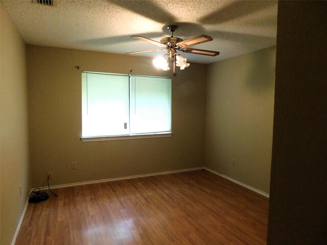 spare room with wood-type flooring, a textured ceiling, and ceiling fan